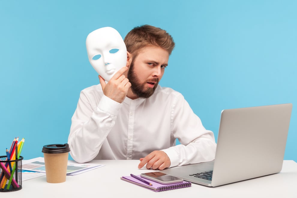 Emotional Businessman Working on Laptop on Blue Background