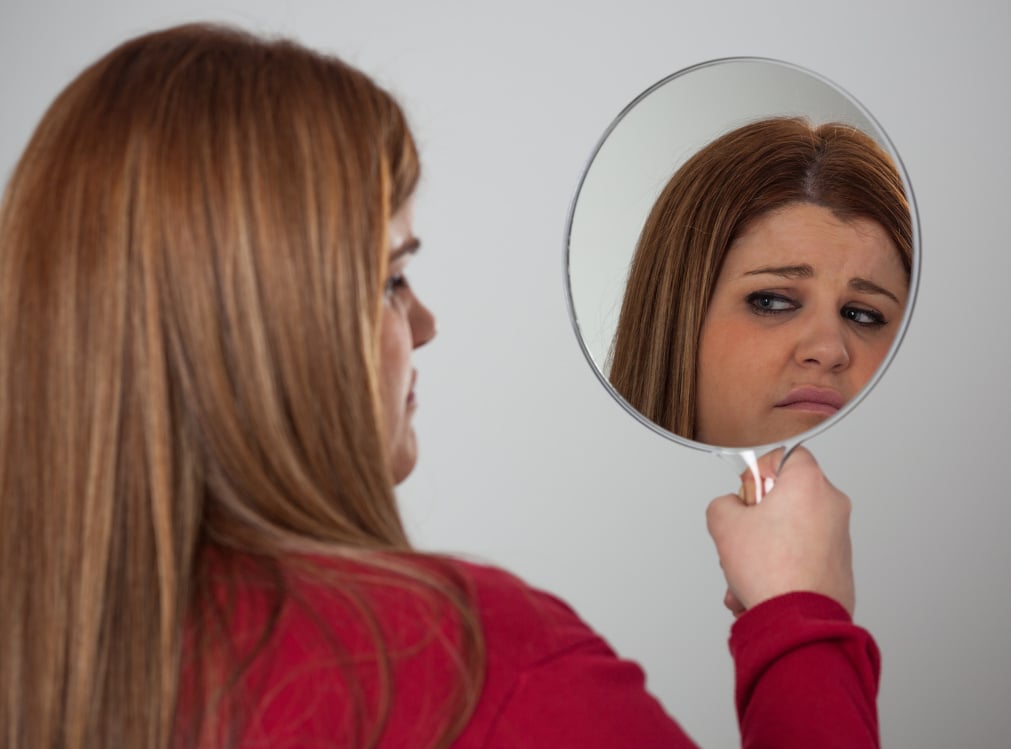 Sad Woman Looking at the Mirror